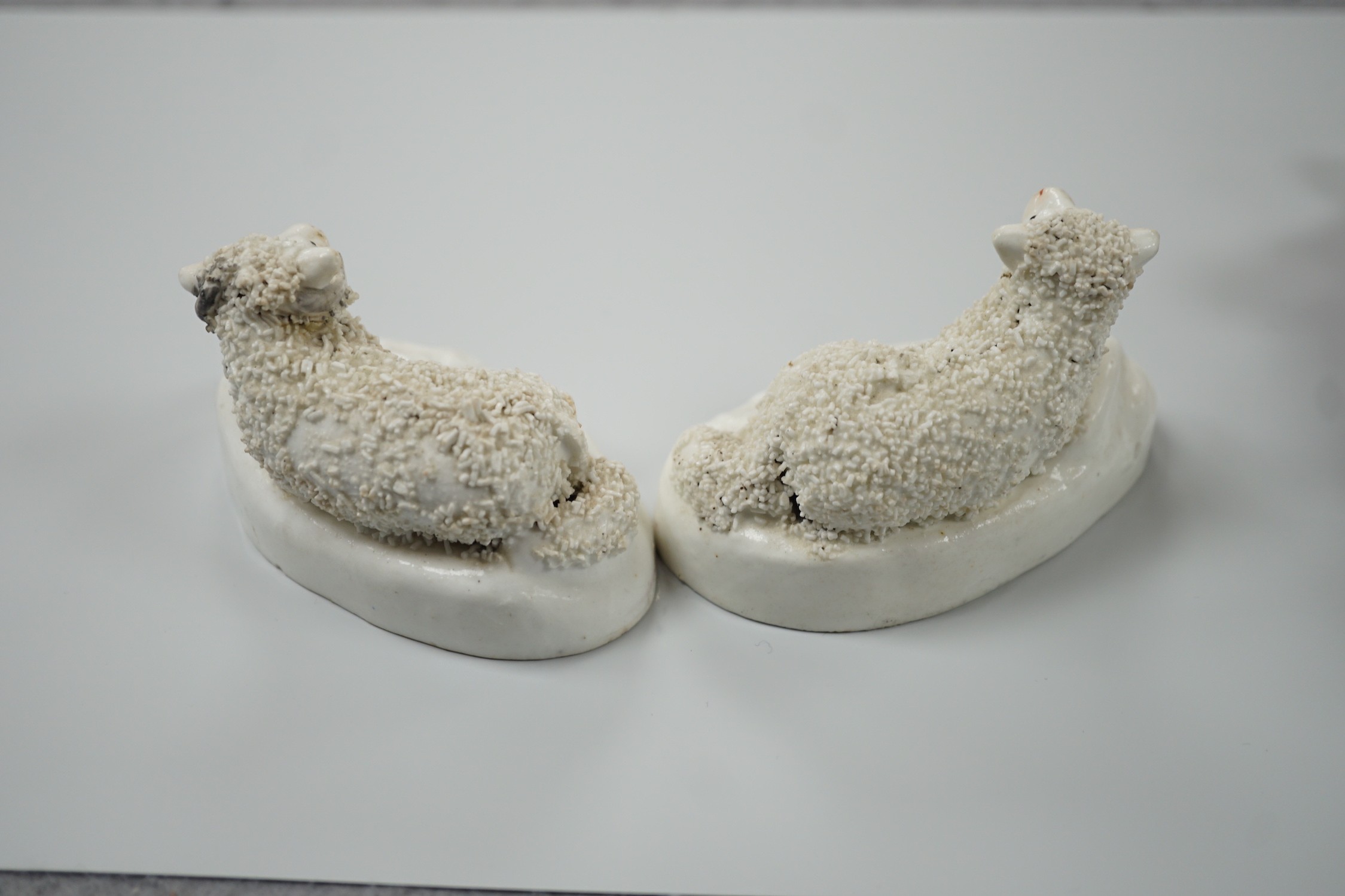 Three small Staffordshire models of recumbent sheep on oval mounted bases, together with a Staffordshire model group of a shepherdess, c.1830-50, (4). Tallest 17.5cm, Provence: Dennis G.Rice collection